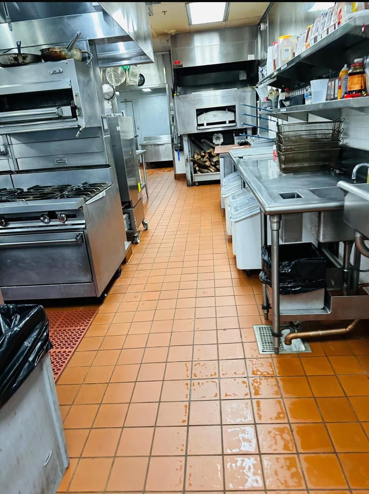 Commercial kitchen line with cleaned equipment and tiled floor