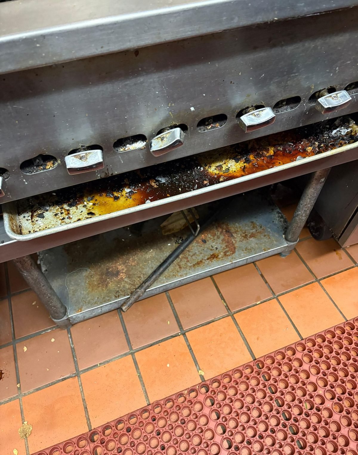 Oven trays and interior with heavy residue before cleaning